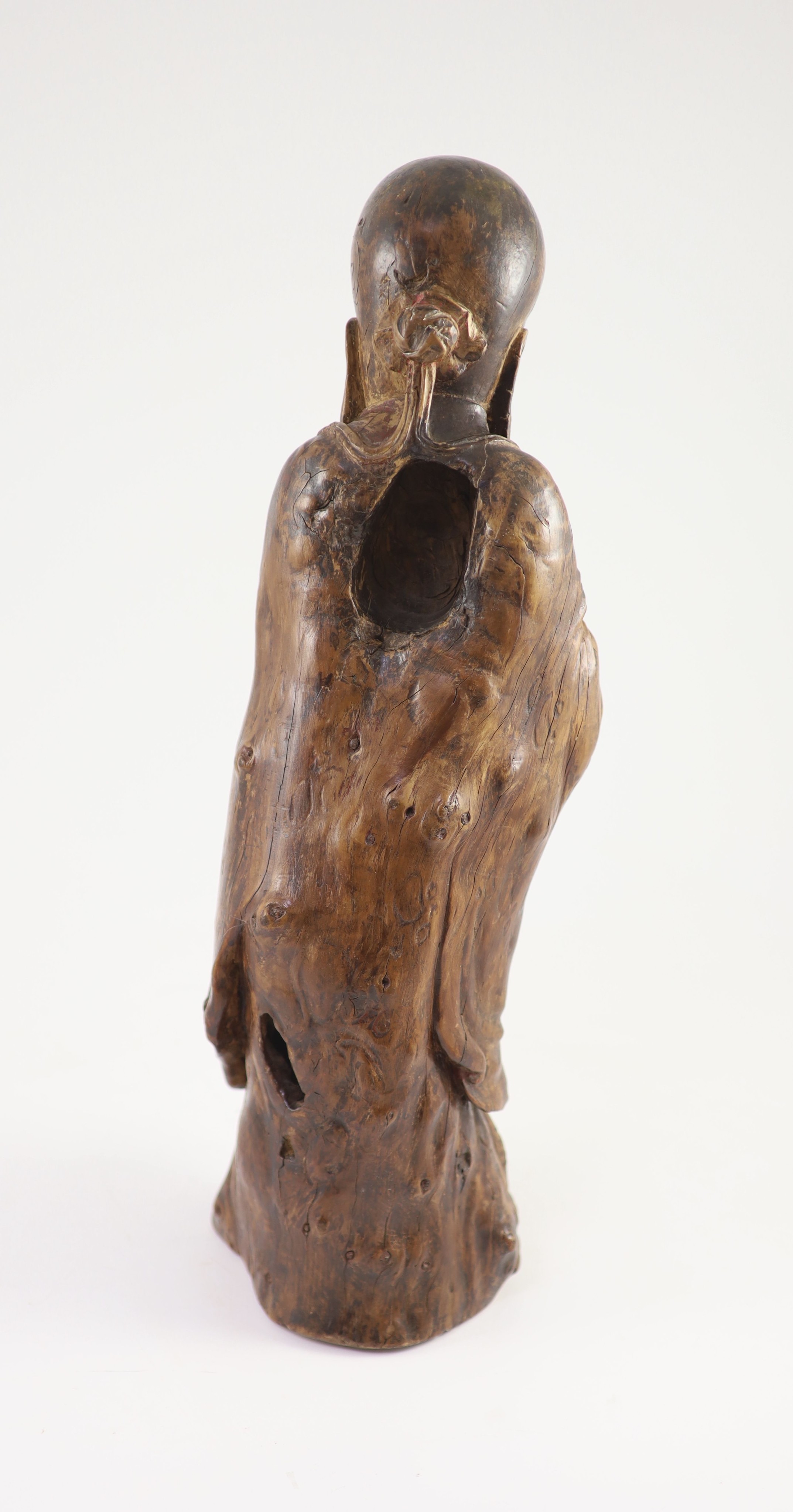 A tall Chinese rootwood figure of Shou Lao, 17th/18th century, 46 cm high, missing the staff in his right hand